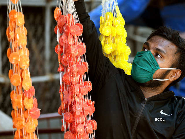 Person selling Diwali items with wearing mask